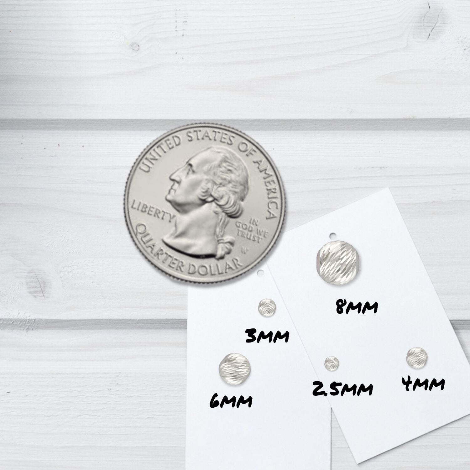 All sizes of our sterling silver multi-cut beads next to a quarter.