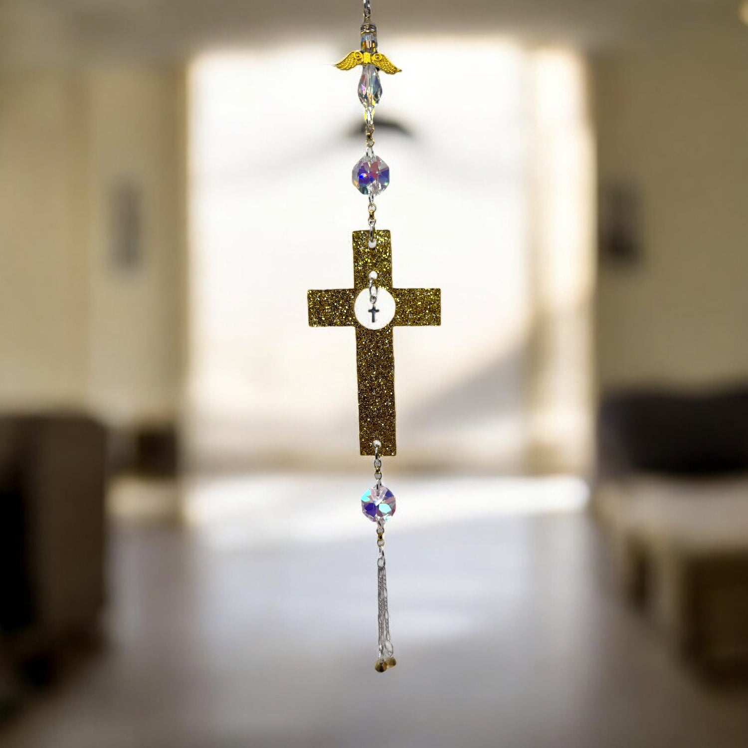 Decorative cross with beads hanging in a blurred indoor setting