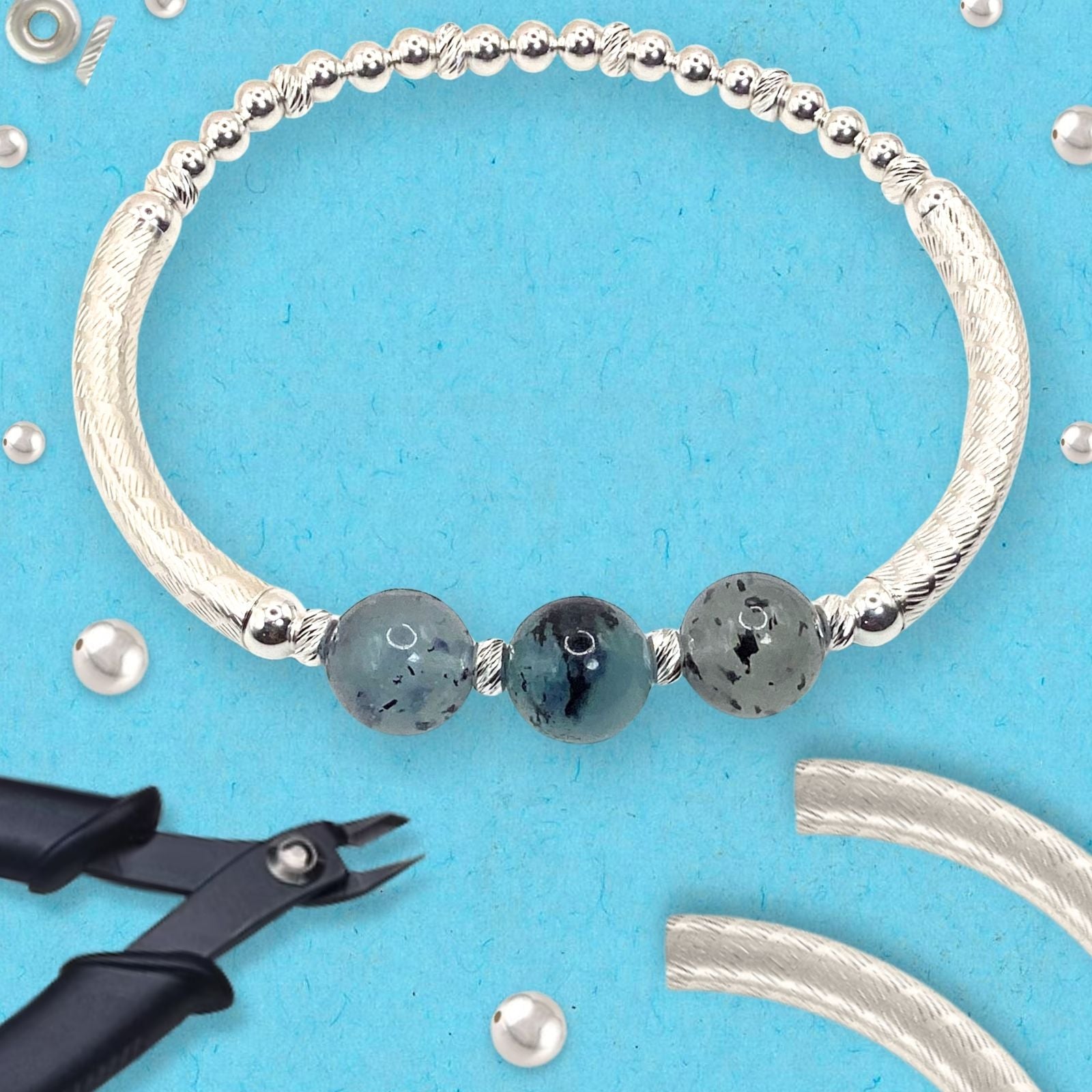 Our Santa Maria Aquamarine Bracket Kit on a purple background with Tools and beads