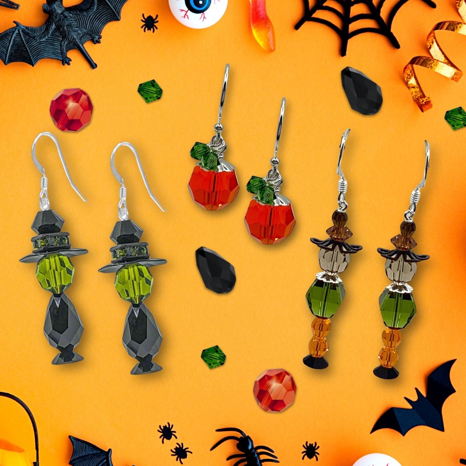 Our Witch, Pumpkin and Scarecrow Halloween Earring Kits on a themed background. 
