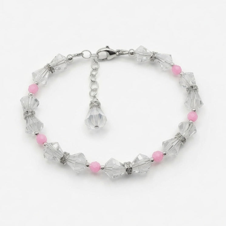 A silver-tone beaded bracelet featuring faceted clear crystal beads and small pink accent beads, displayed on a clean white background.