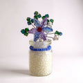Decorative glass jar with a colorful flower on a white background