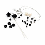 Jewelry-making supplies including beads, wires, for Wednesday Inspired earring kit.