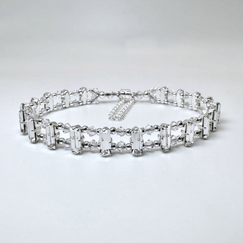 A completed bracelet crafted with sterling silver and clear Swarovski crystals, featuring a magnetic clasp and baguette settings.