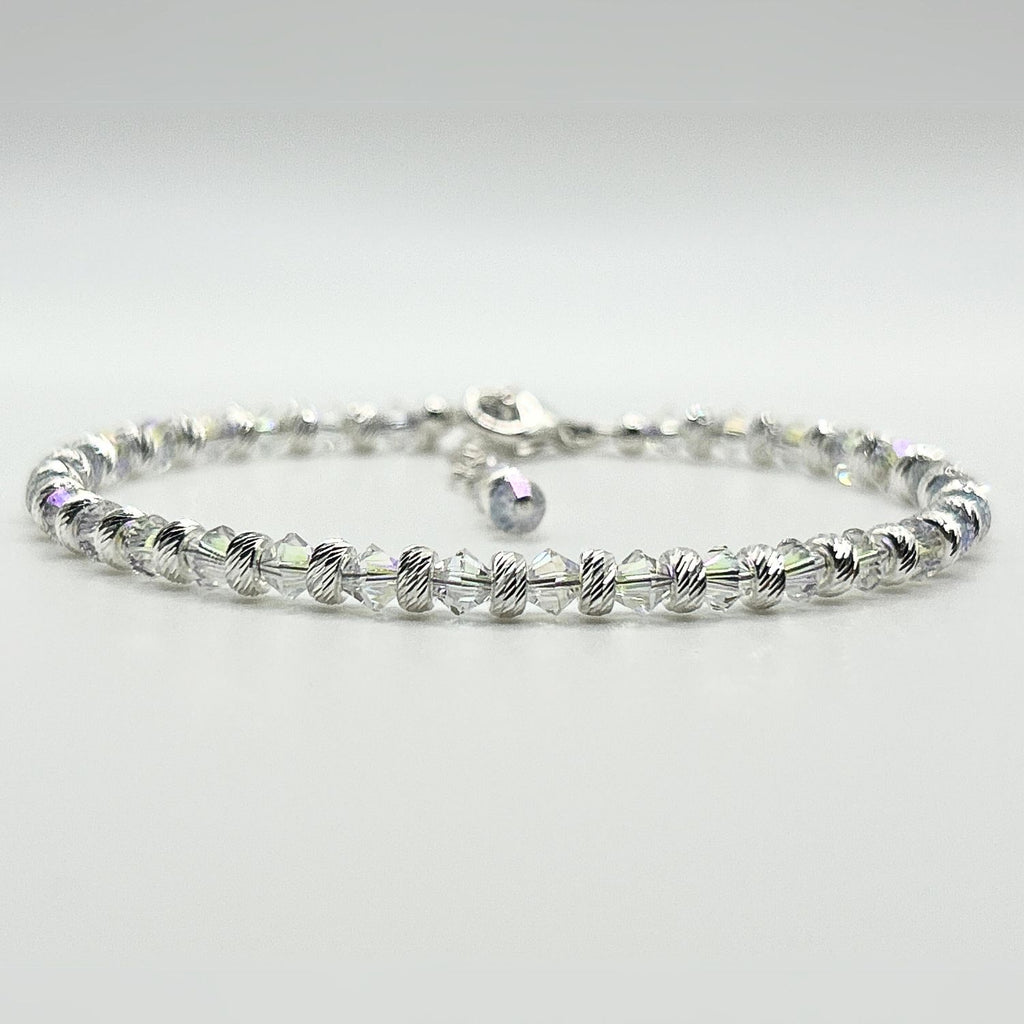 A completed bracelet made with the Endless Shimmer Bracelet Kit, featuring shimmering biconic beads, sterling silver beads, and a sterling silver clasp.