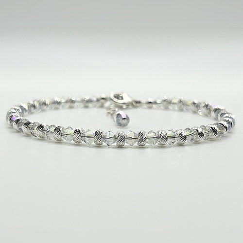 A completed bracelet made with the Endless Shimmer Bracelet Kit, featuring shimmering biconic beads, sterling silver beads, and a sterling silver clasp.