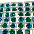 Grid of green Swarovski Majestic Pendants in a white container