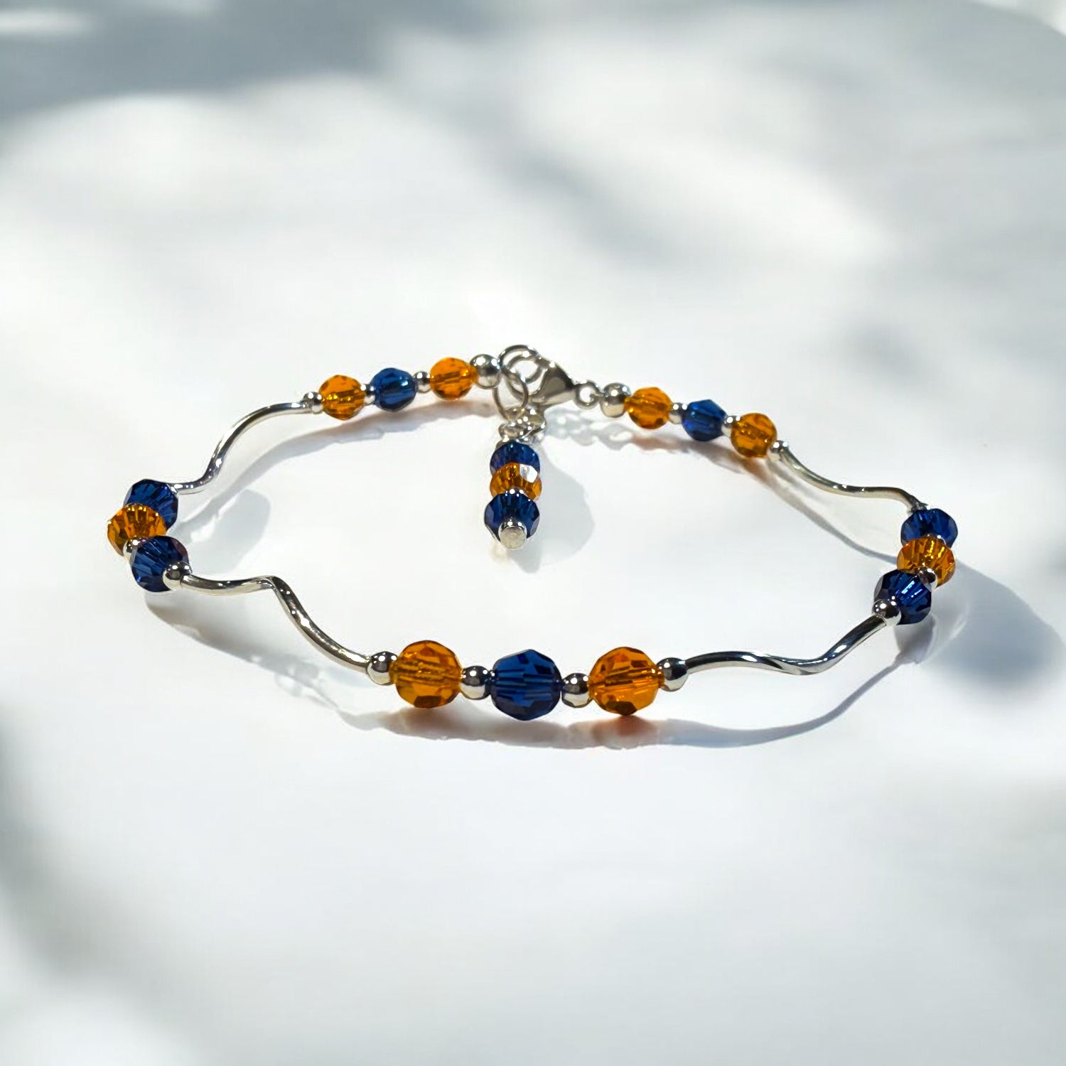 Beaded bracelet with blue and orange beads on a white background