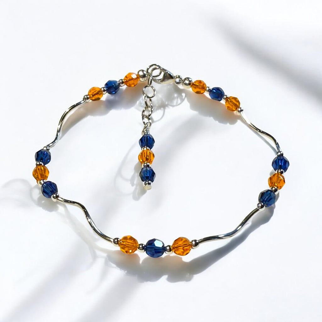 Bracelet with blue and orange beads on a white background