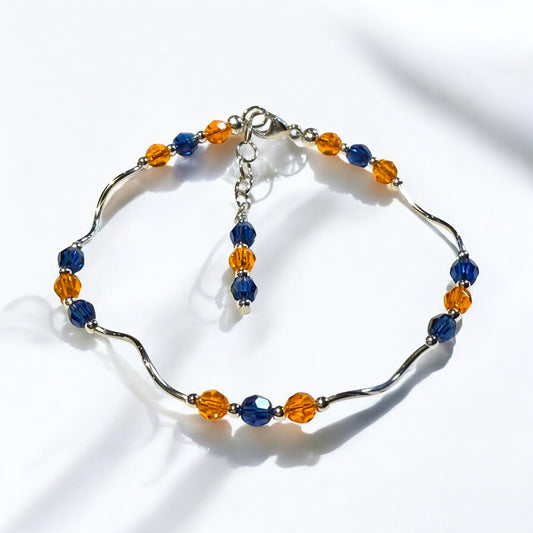Bracelet with blue and orange beads on a white background