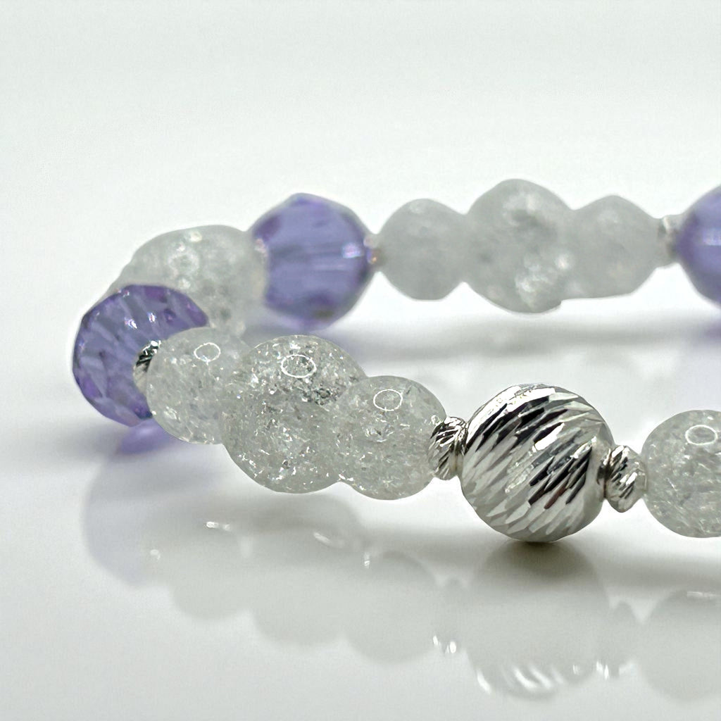 bracelet with purple and silver beads on a white background