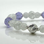 bracelet with purple and silver beads on a white background
