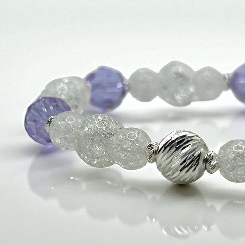 bracelet with purple and silver beads on a white background