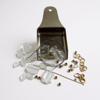 Jewelry-making supplies including clear beads, gold chain links, and a metal scoop on a white background.