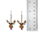 Pair of beaded earrings with a ruler for scale on a white background