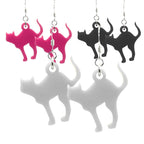 Cat-shaped earrings in pink, black, and white on a white background
