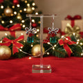 Earrings with red and green beads on a stand against a festive background with Christmas decorations.