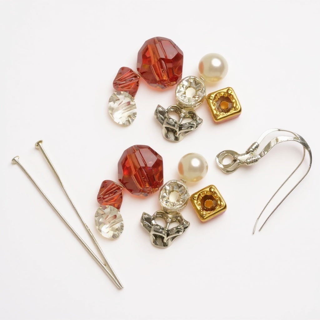 Assorted jewelry components including beads and earring hooks on a white background
