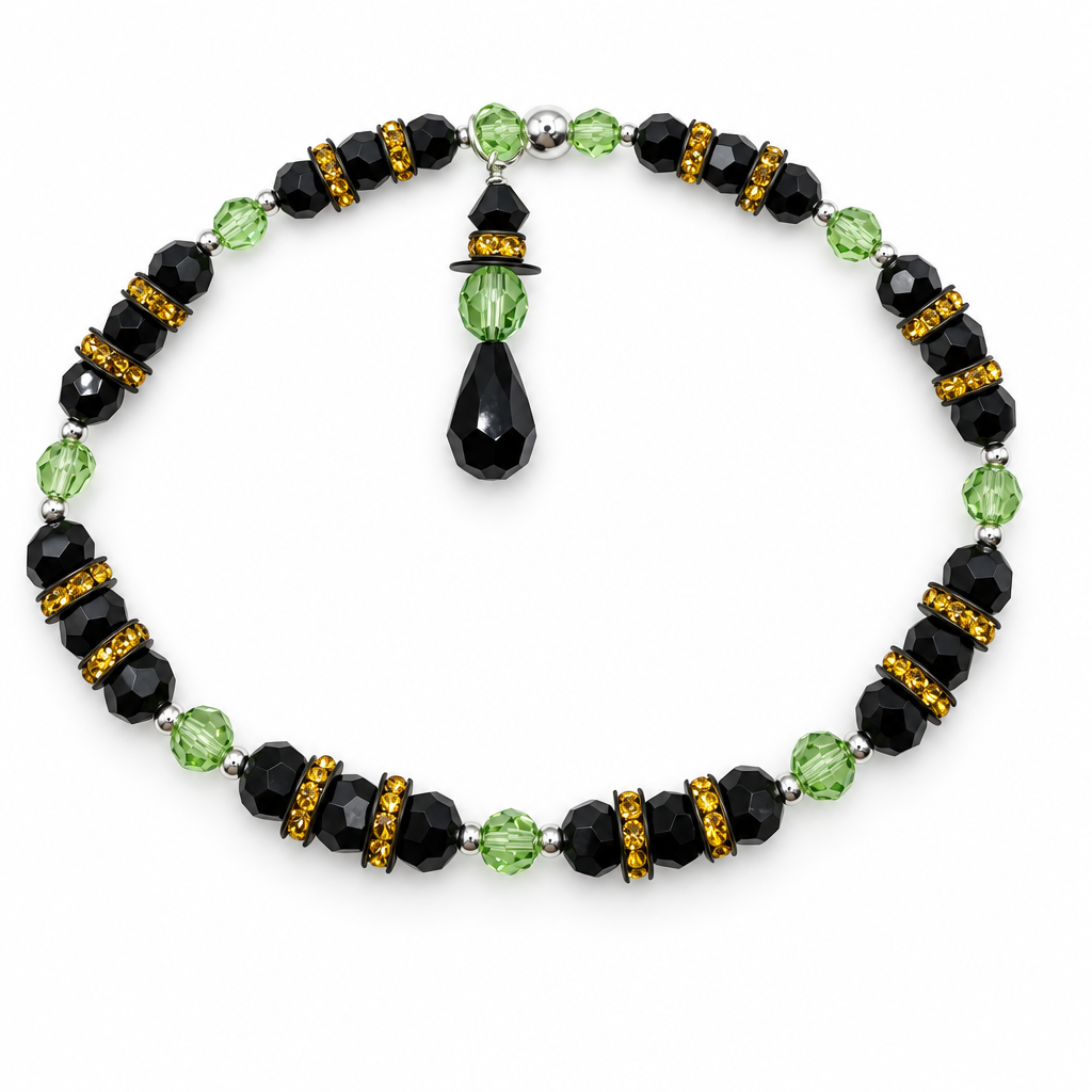 Black and green beaded bracelet with gold accents and a teardrop charm on a white background