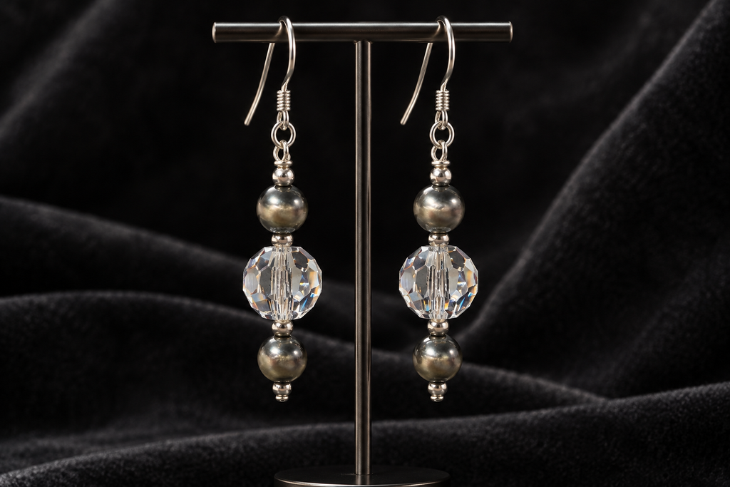 Crystal Moonlight and Navajo pearl earrings displayed against charcoal velvet