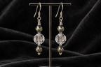 Crystal Moonlight and Navajo pearl earrings displayed against charcoal velvet