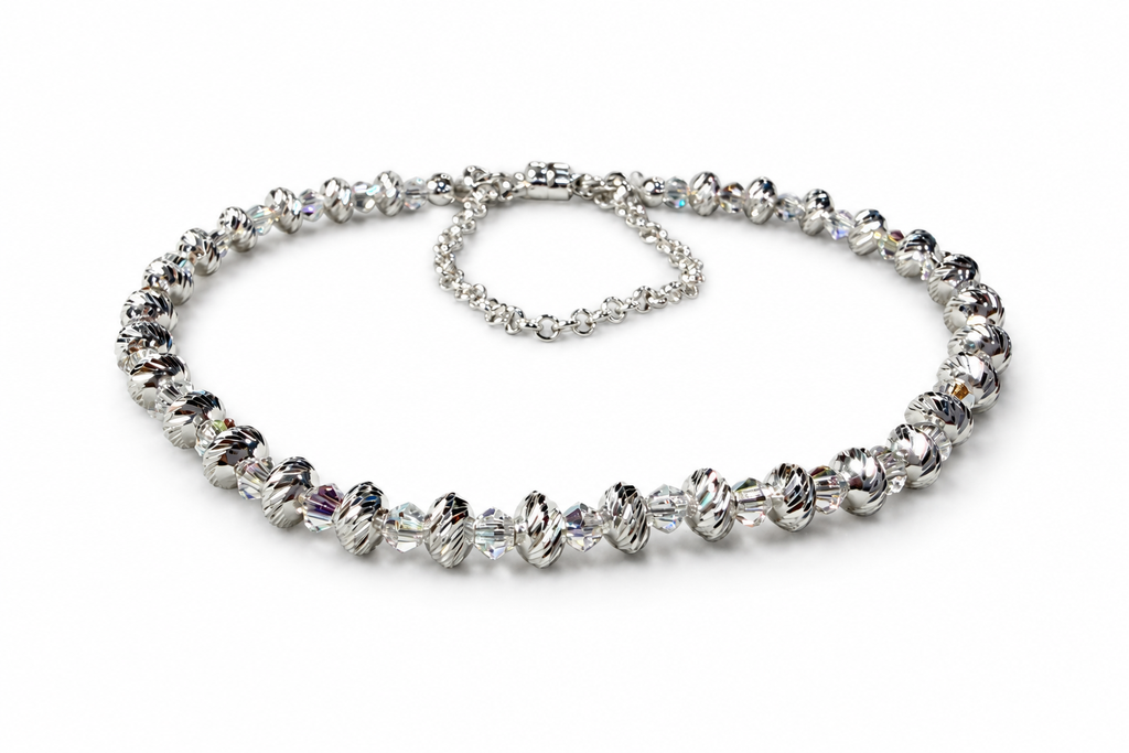 Assembled Swarovski and multicut saucer bead bracelet on a white background
