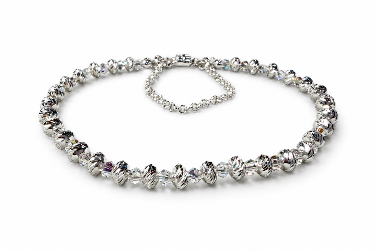 Assembled Swarovski and multicut saucer bead bracelet on a white background