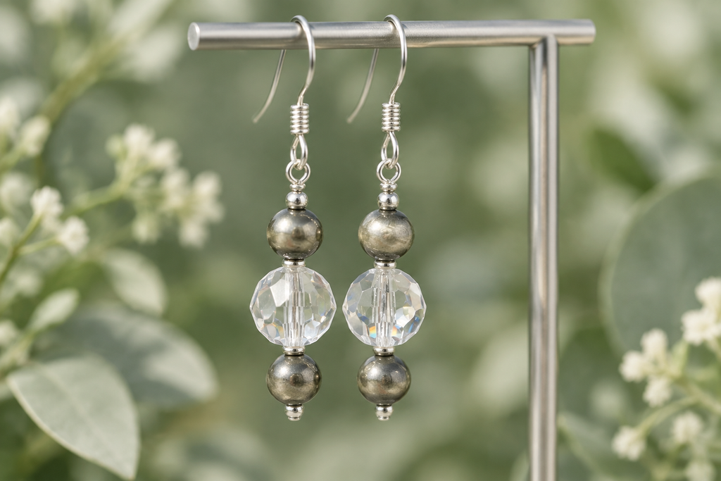 Crystal Moonlight and Navajo pearl earrings with a soft sage botanical background