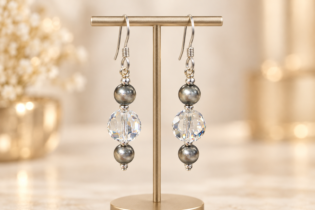 Crystal Moonlight and Navajo pearl earrings displayed on an elegant stand