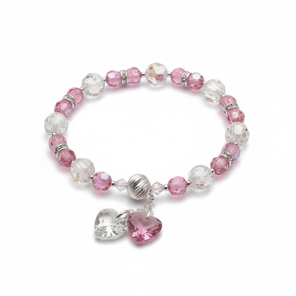 Pink and clear beaded bracelet with heart-shaped charms on a white background